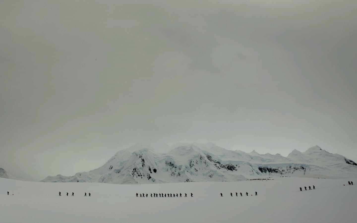 Snow-covered mountain landscape with people walking